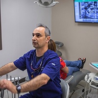 Dr. Kar in dental exam room withpatient