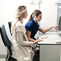 Patient and dental team member reviewing scan results