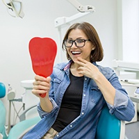 young woman admiring her new dental implants in Allen