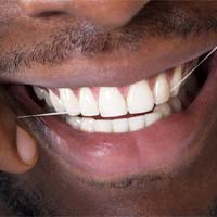 Close-up of man’s healthy smile as he flosses