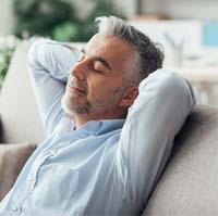 Man resting comfortably at home after oral surgery