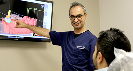 Dr. Kar showing patient a dental implant plan