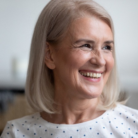 woman smiling while looking out the window