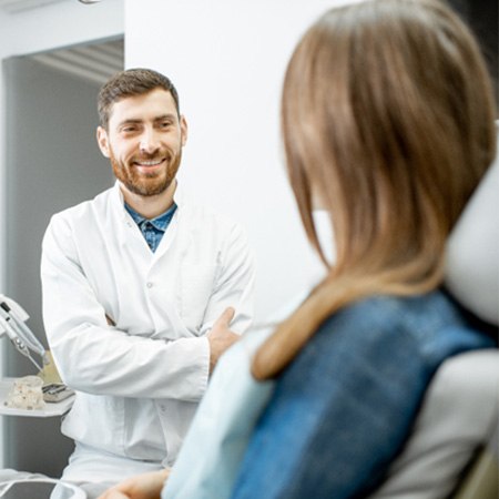 dentist smiling while talking to dentist 