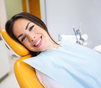 Smiling dental patient in treatment chair