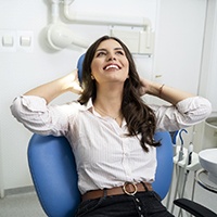 Relaxed female dental patient reclining in operatory chair