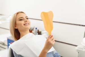 happy dental patient with mirror