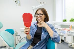 a woman smiling in the mirror