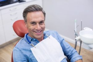 Happy patient at appointment to maximize dental insurance benefits