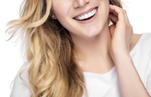 Woman showing off beautiful smile with porcelain veneers