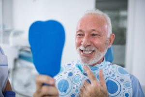 Dental patient smiling after replacing a metal crown