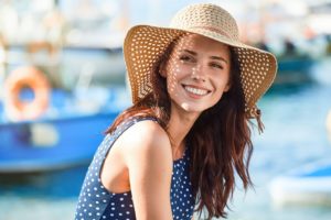 Woman in sunhat, smiling with dental implants in Allen