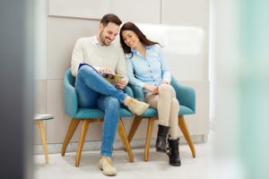 Young couple in dental office, learning about dental financing