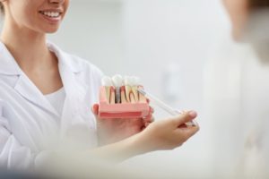 Dental team member explaining dental implants