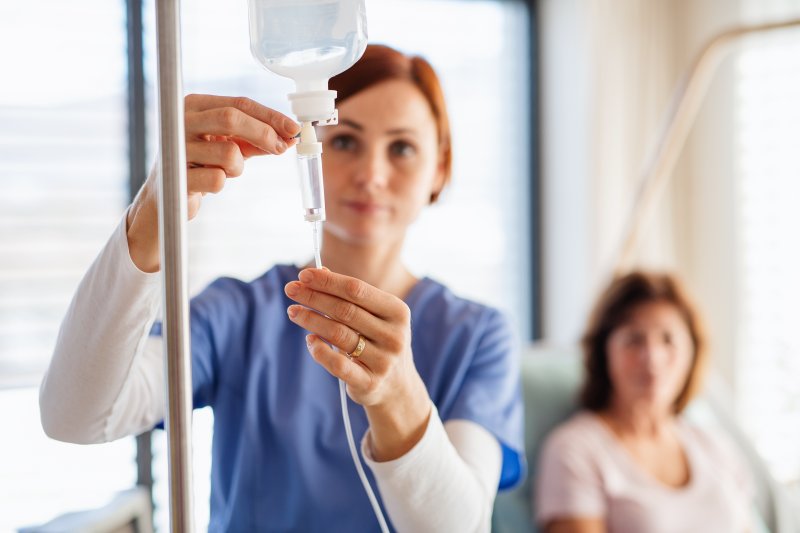 A dentist prepping a patient for IV sedation