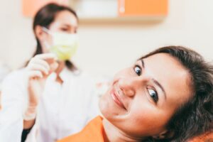 Dental patient smiling after tooth extraction